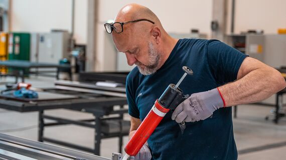 Fabricator preparing aluminium profiles in the workshop.